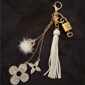 Authentic Louis Vuitton brass lock and key with unbranded charm and tassel
